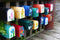 bunch of brightly painted mailboxes with painted flowers