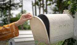 hand of personal is opening the classical vintage style mailbox to check to letter inside