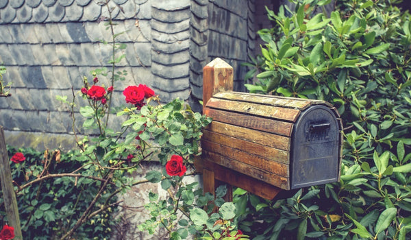 wooden mail box in flower garden